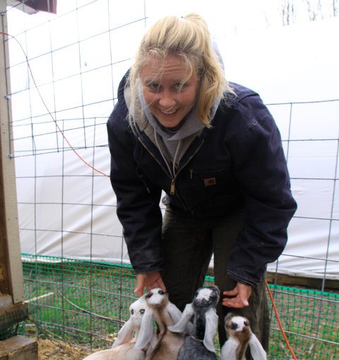 Sara Stockwood posing with baby goats