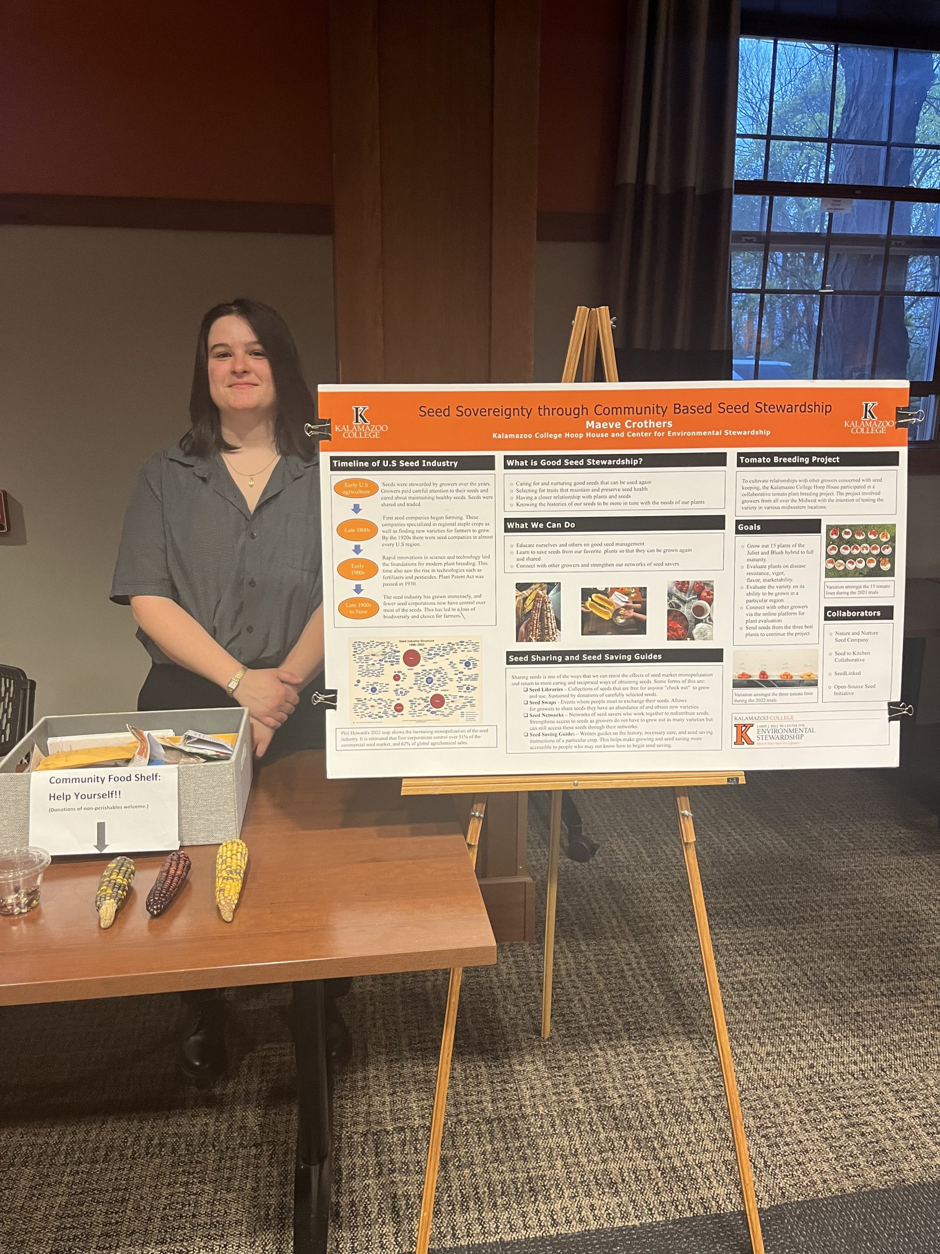 Maeve Crothers standing next to their senior project poster