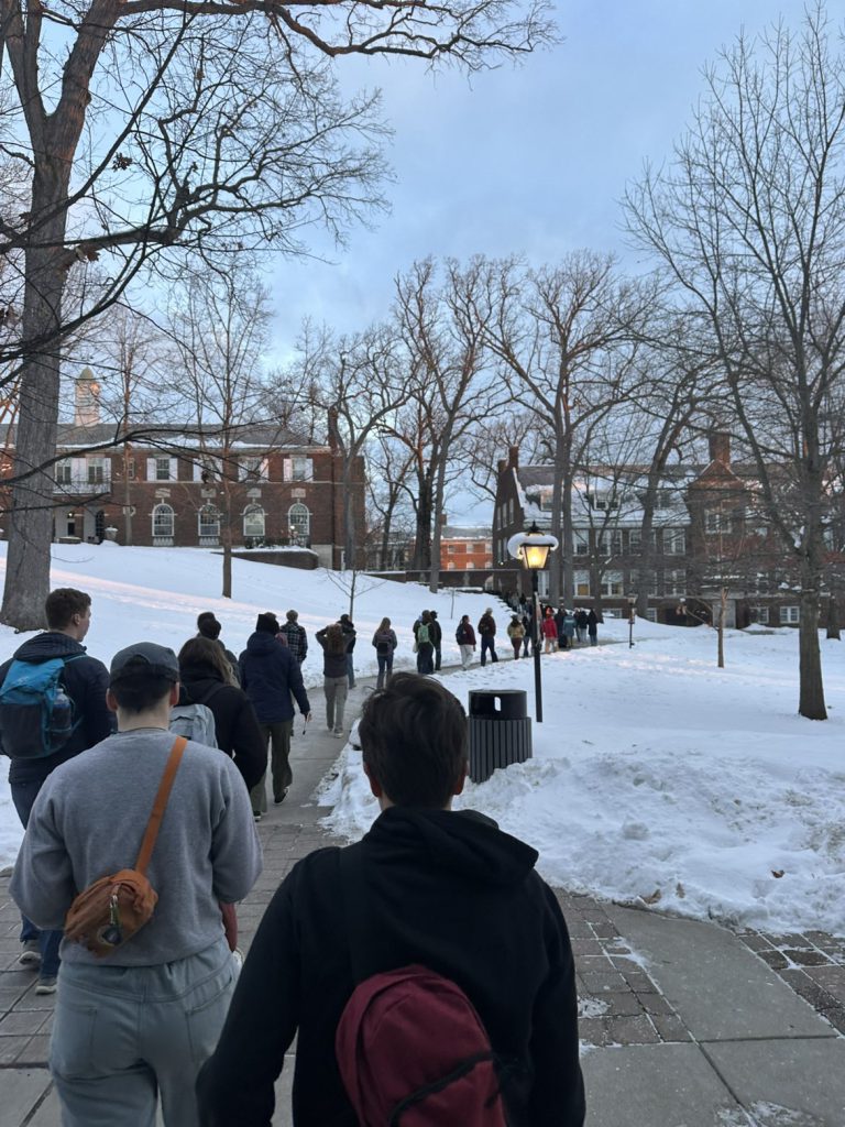 Line of students walking across the quad