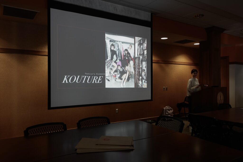 Slide on a screen that says "Kouture" in a dark room